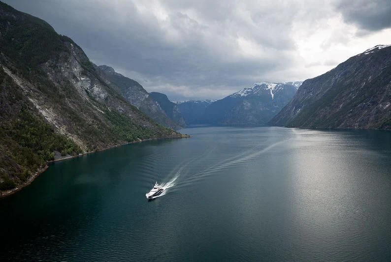 a body of water with mountains in the background aboard JULIA Yacht for Sale