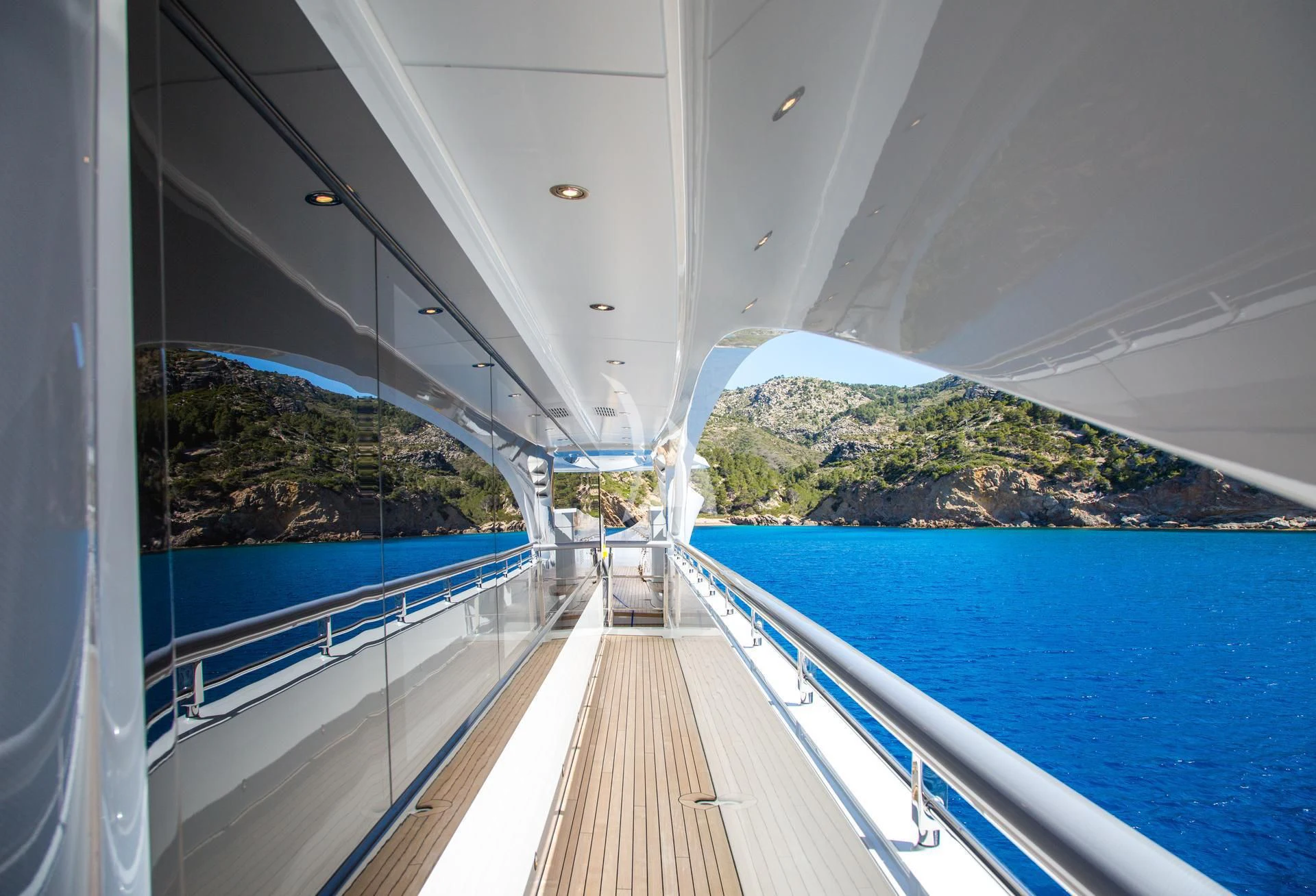 a long wooden dock leading to a large body of water aboard JULIA Yacht for Sale