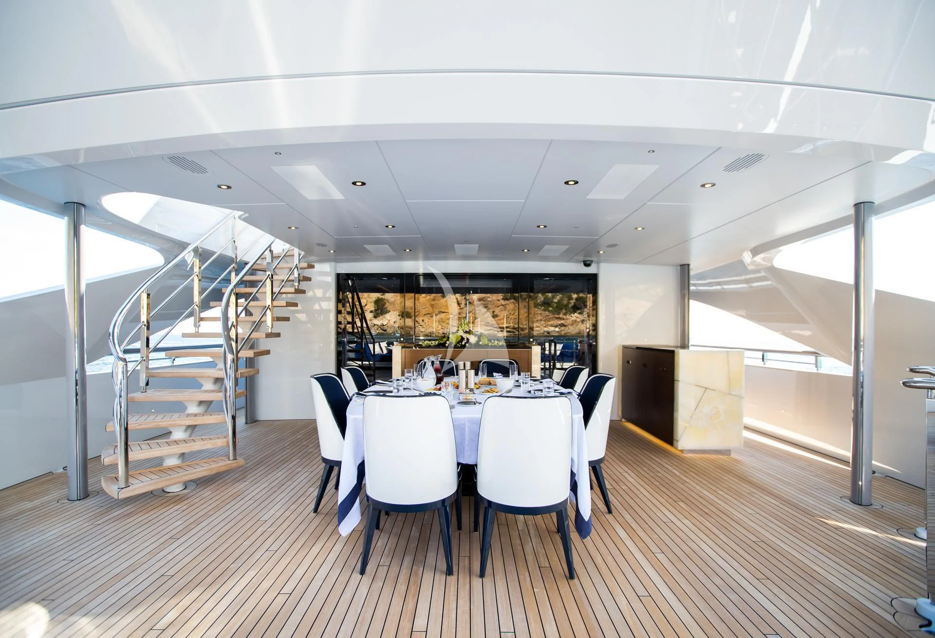 a large dining room with a staircase aboard JULIA Yacht for Sale
