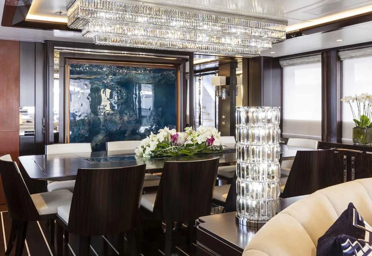 a room with tables and chairs aboard JULIA Yacht for Sale