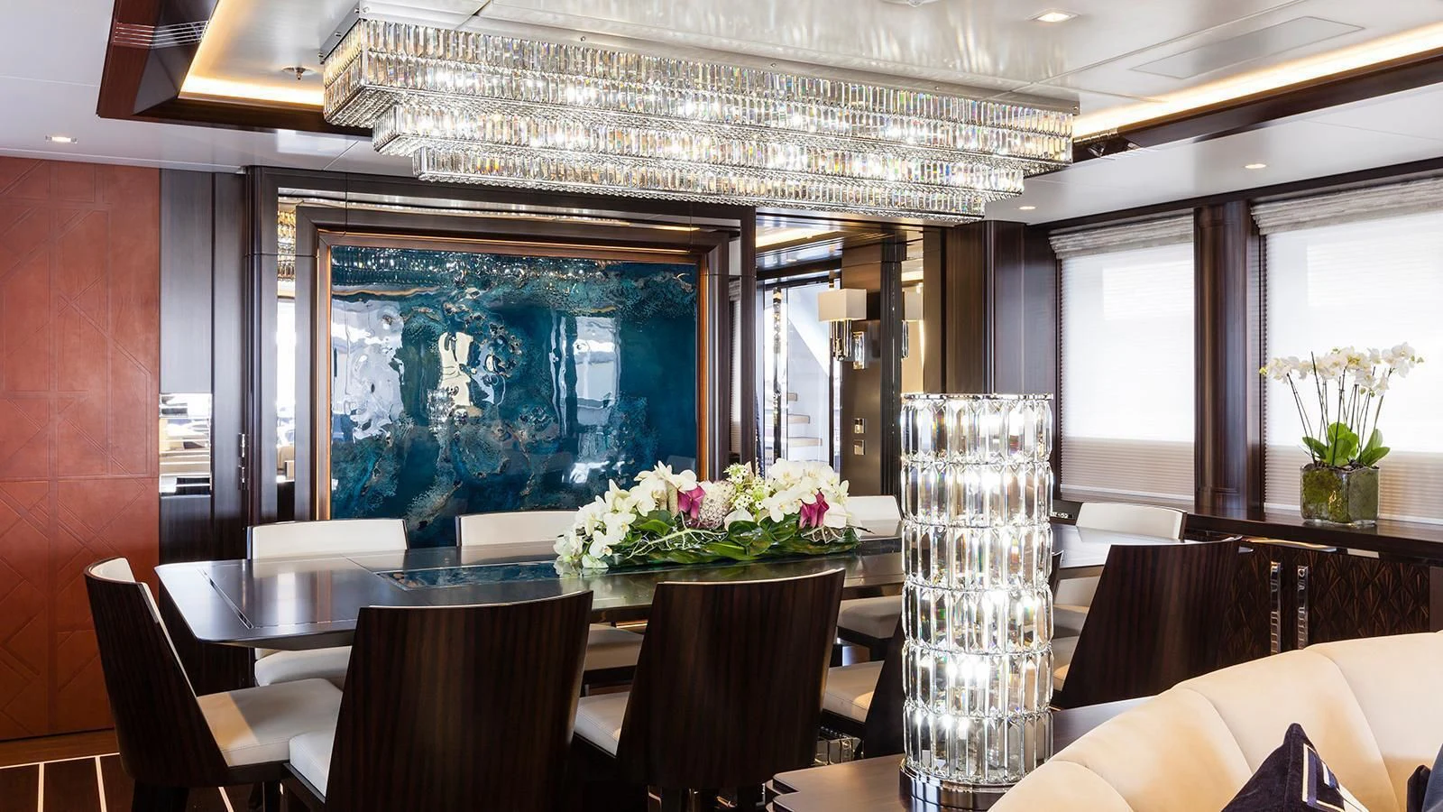 a room with tables and chairs aboard JULIA Yacht for Sale