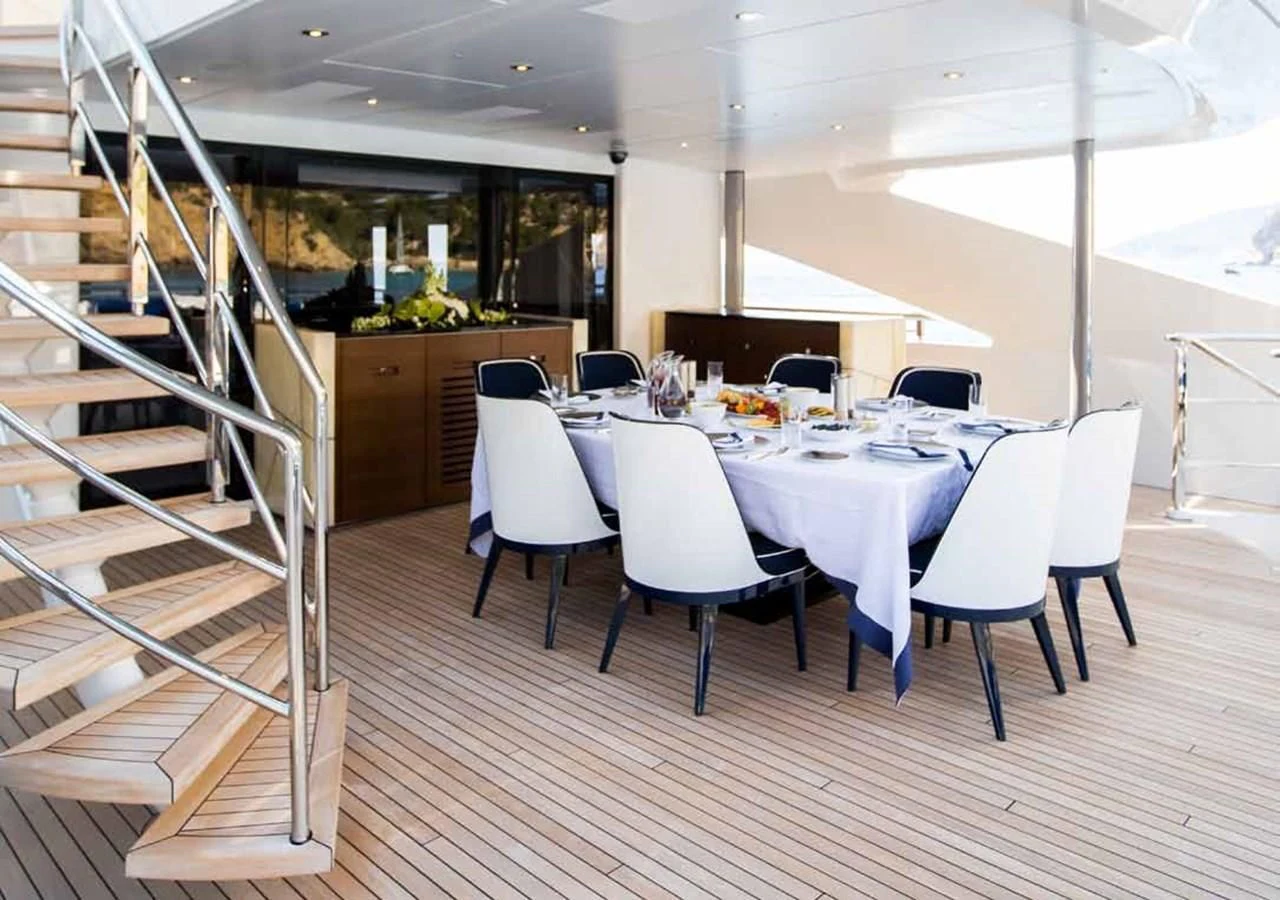 a room with a table and chairs aboard JULIA Yacht for Sale