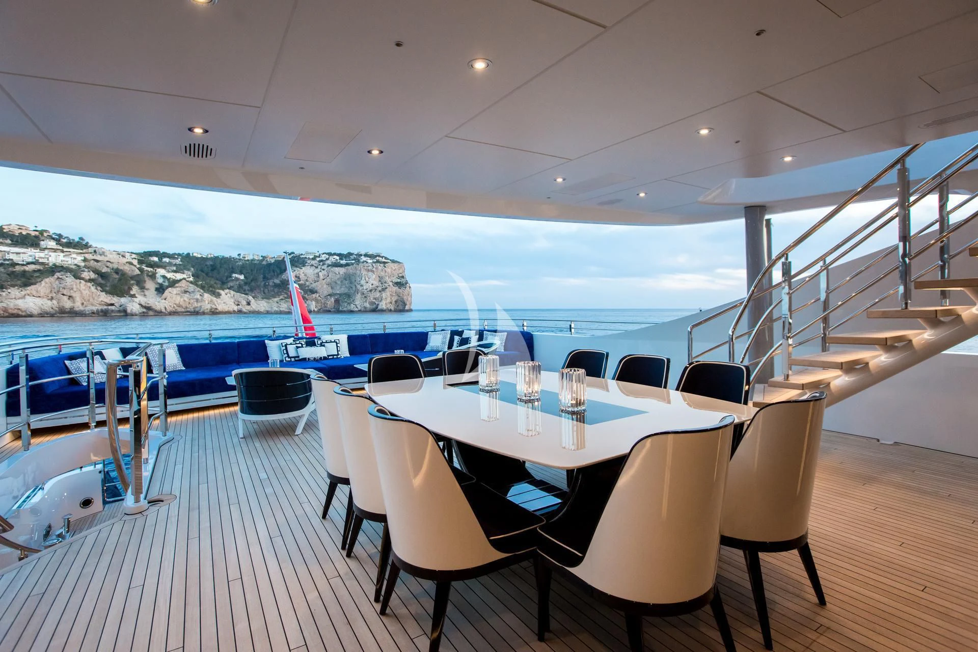 a room with a table chairs and a view of the water aboard JULIA Yacht for Sale