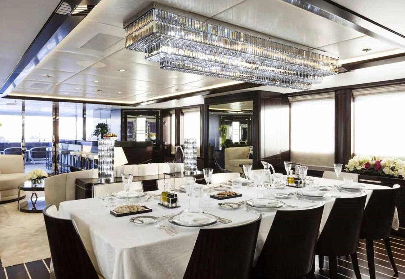 a room with tables and chairs aboard JULIA Yacht for Sale