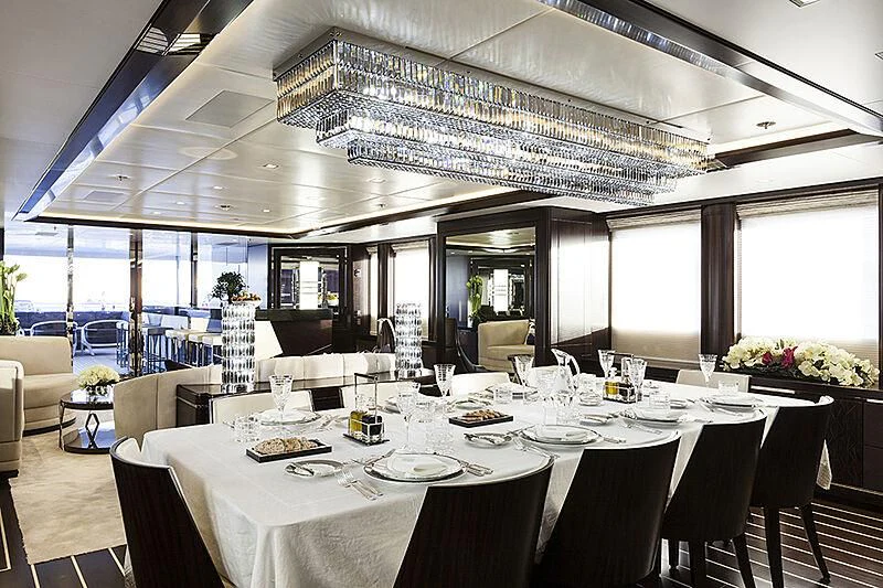 a large room with tables and chairs aboard JULIA Yacht for Sale