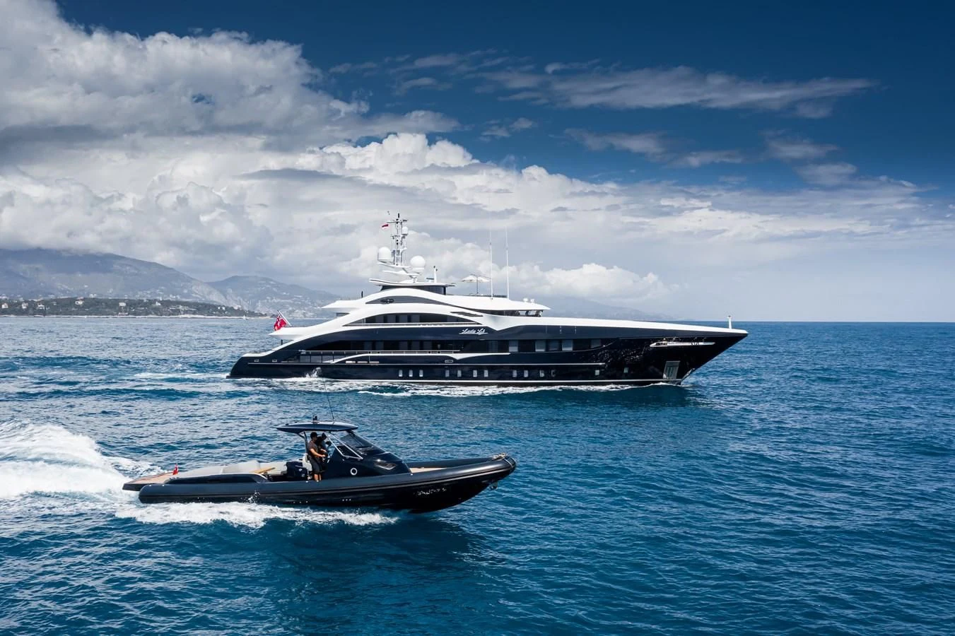 a boat in the water with a cruise ship in the background aboard JULIA Yacht for Sale