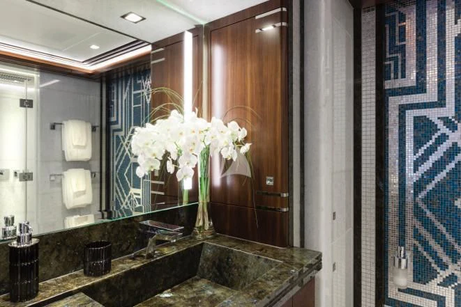 a bathroom with a marble countertop aboard JULIA Yacht for Sale