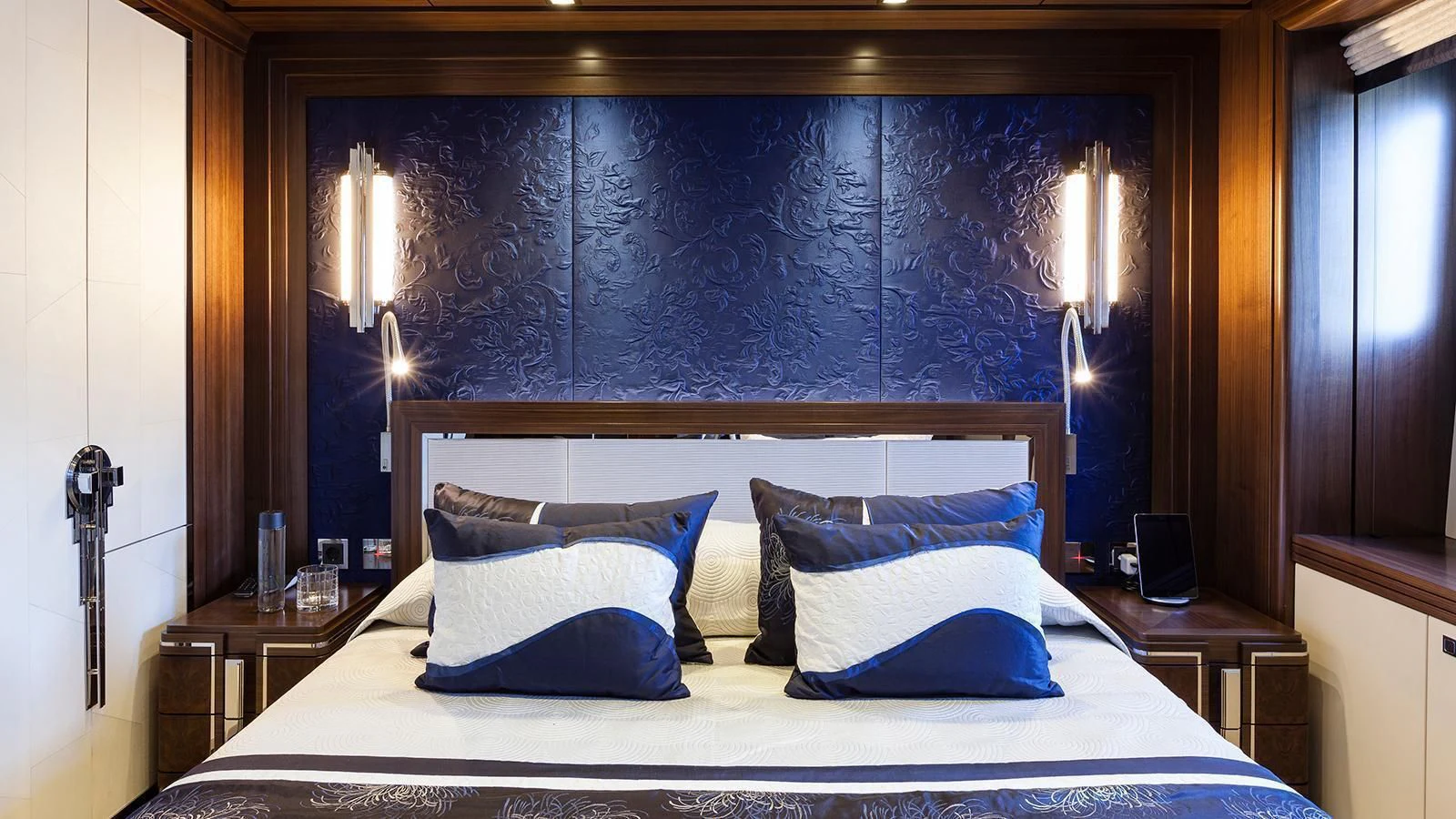 a bed with a white sheet and pillows aboard JULIA Yacht for Sale