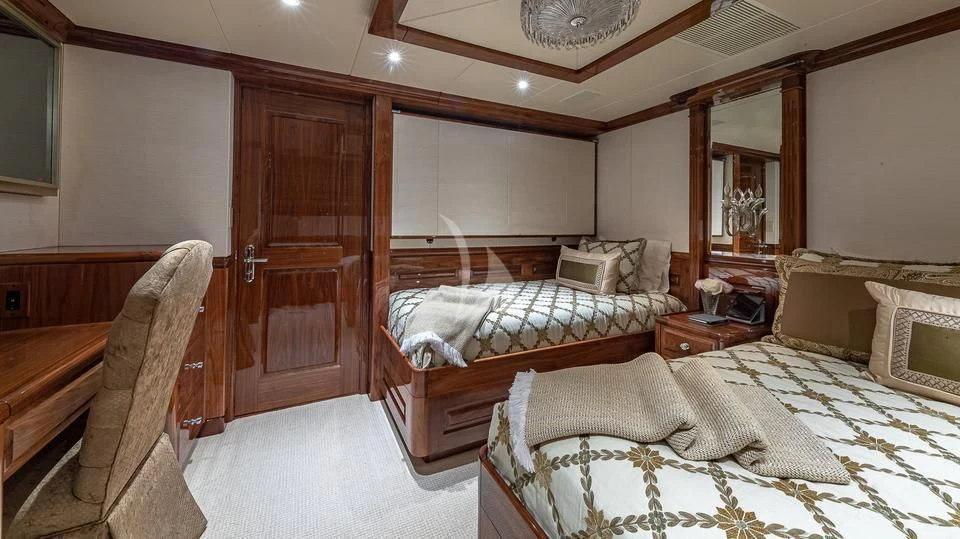 a room with a bed and a chair aboard SILVER LINING Yacht for Sale