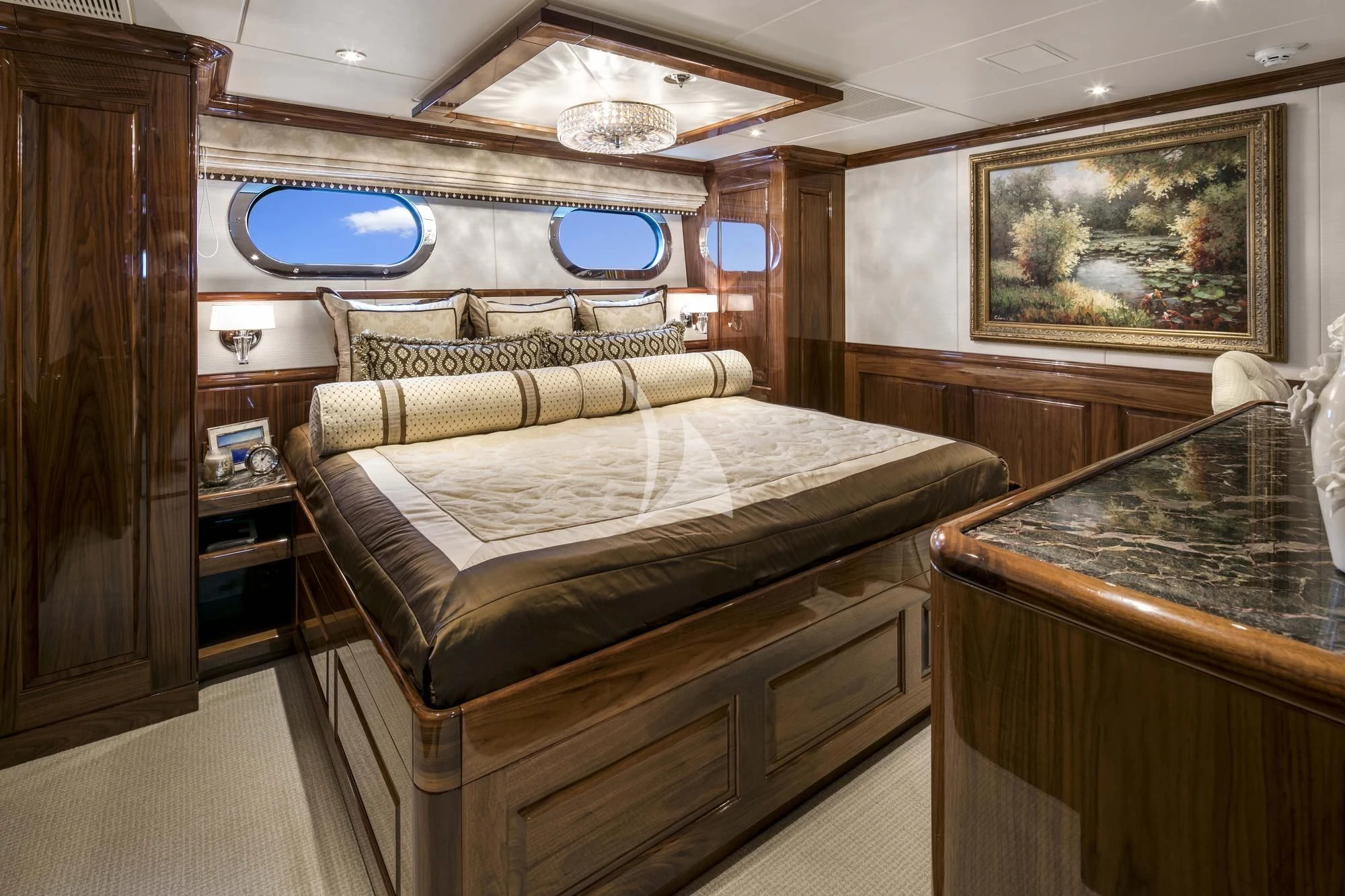 a bedroom with a bed and a table aboard SILVER LINING Yacht for Sale