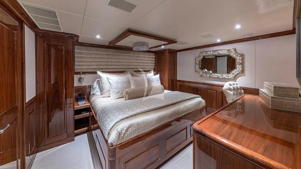 a bedroom with a bed and a mirror aboard SILVER LINING Yacht for Sale