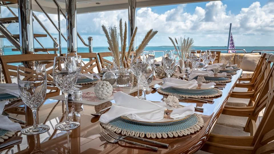 a table set with plates and glasses aboard SILVER LINING Yacht for Sale