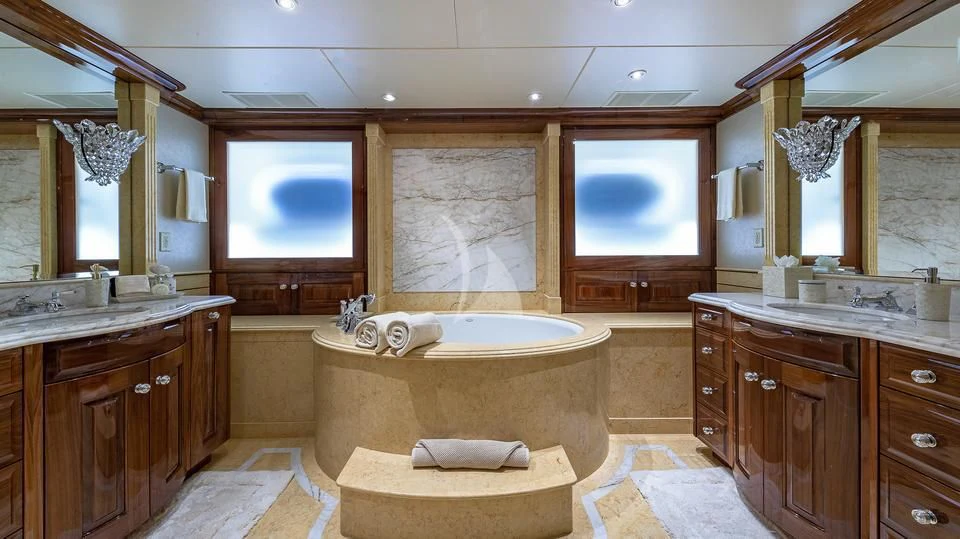 a bathroom with a tub sink and cabinets aboard SILVER LINING Yacht for Sale