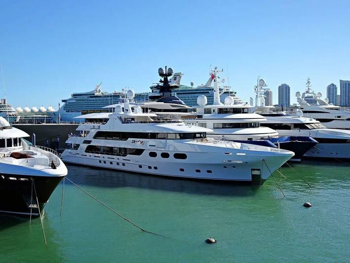 a group of boats in a harbor with USS Midway Museum in the background aboard SILVER LINING Yacht for Sale