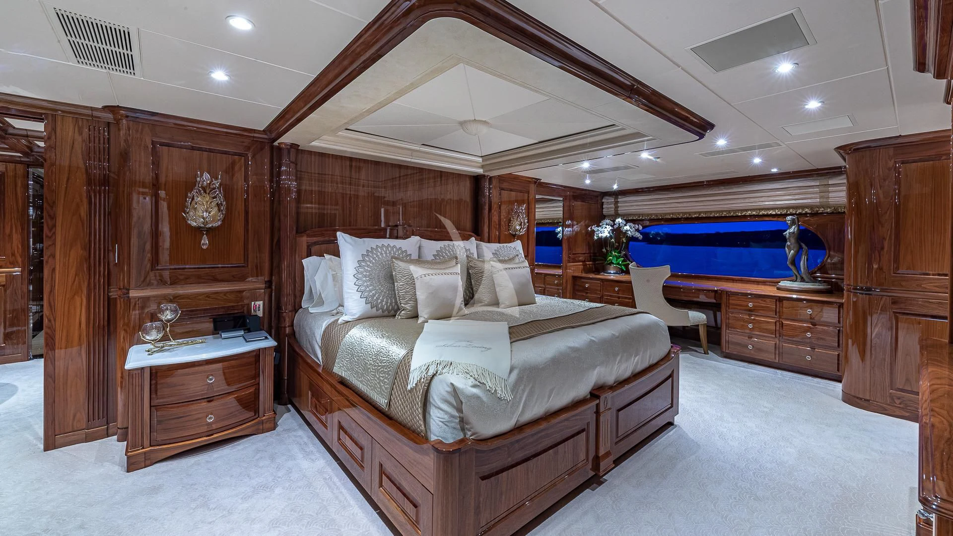 a bedroom with a bed and a wood cabinet aboard SILVER LINING Yacht for Sale