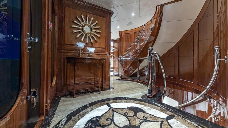a room with a wood door and a chandelier aboard SILVER LINING Yacht for Sale