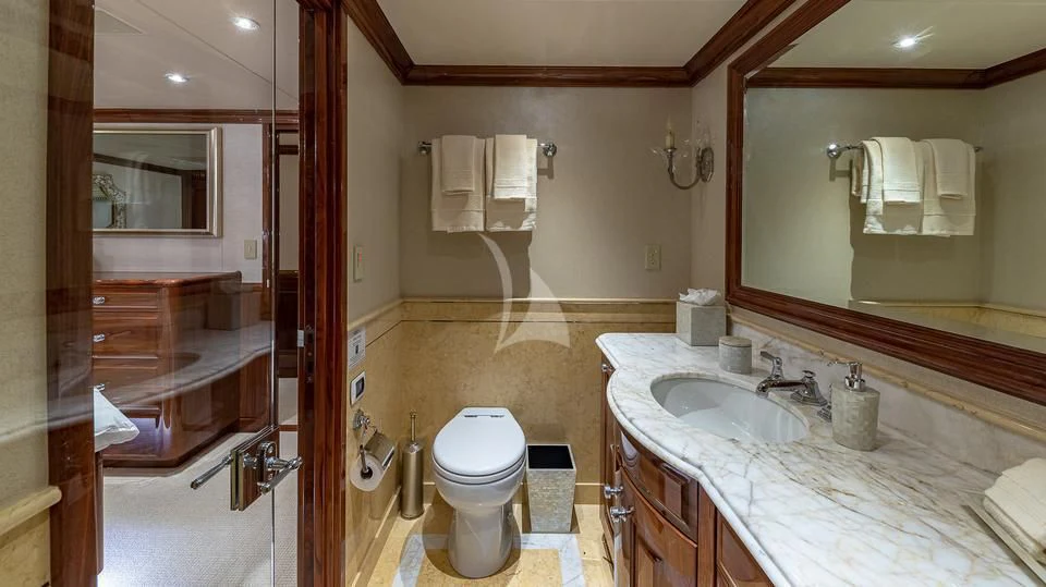 a bathroom with a sink toilet and a mirror aboard SILVER LINING Yacht for Sale