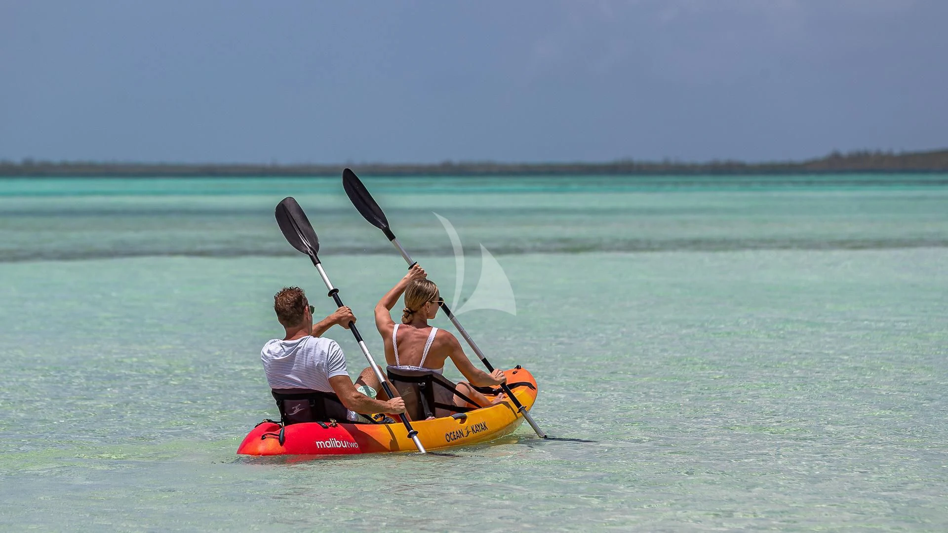 a couple of people in a kayak holding a parasail aboard SILVER LINING Yacht for Sale