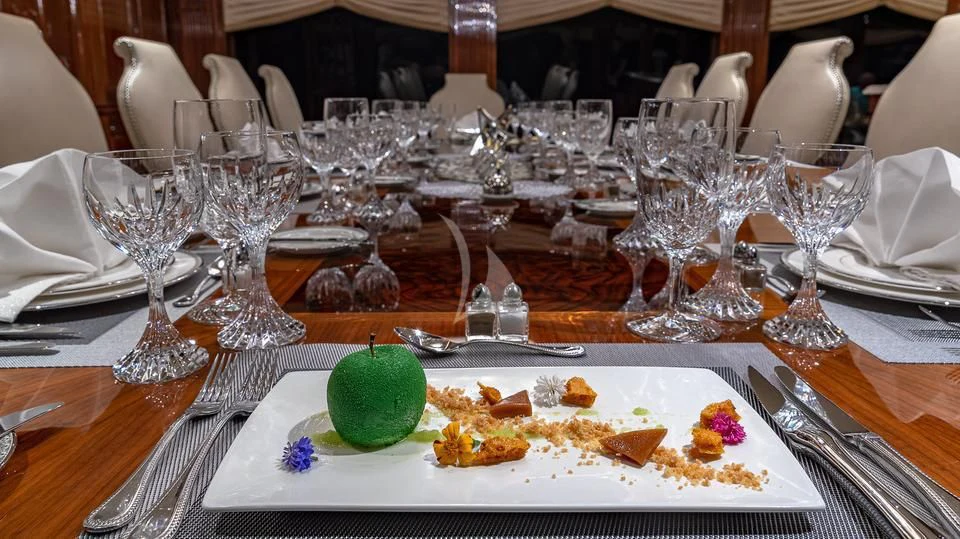 a table with food and glasses aboard SILVER LINING Yacht for Sale