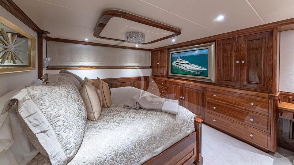 a bed with a television on the wall aboard SILVER LINING Yacht for Sale