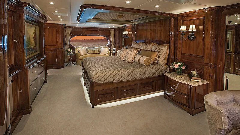 a bedroom with a bed and a dresser aboard SILVER LINING Yacht for Sale