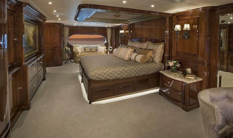 a bedroom with a bed and a dresser aboard SILVER LINING Yacht for Sale