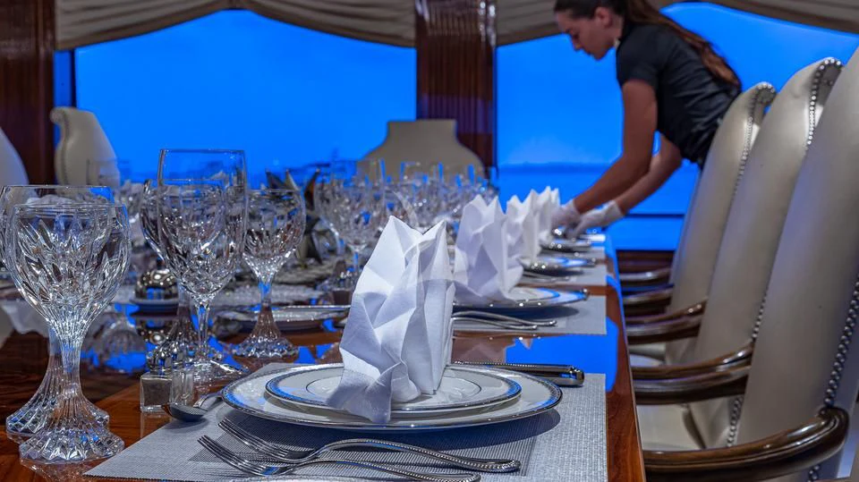 a person cutting a cake aboard SILVER LINING Yacht for Sale