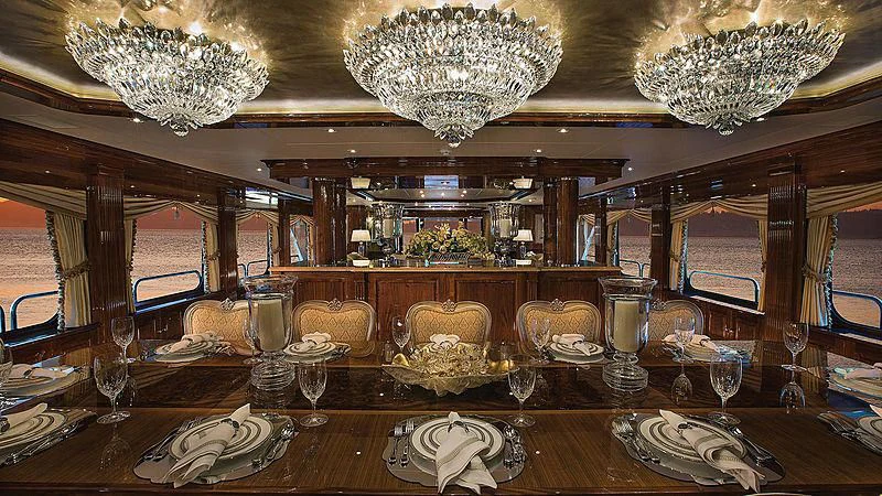 a large room with a chandelier and a table aboard SILVER LINING Yacht for Sale