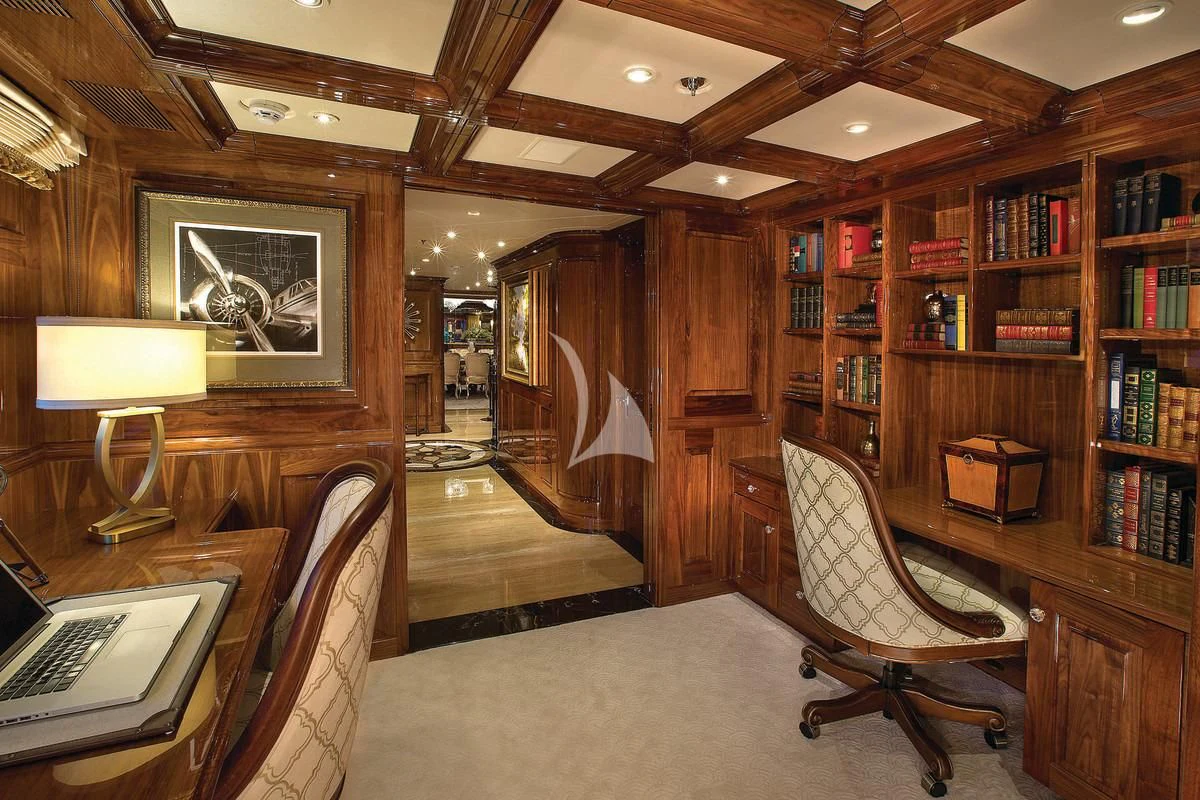 a living room with a bookcase and a desk aboard SILVER LINING Yacht for Sale