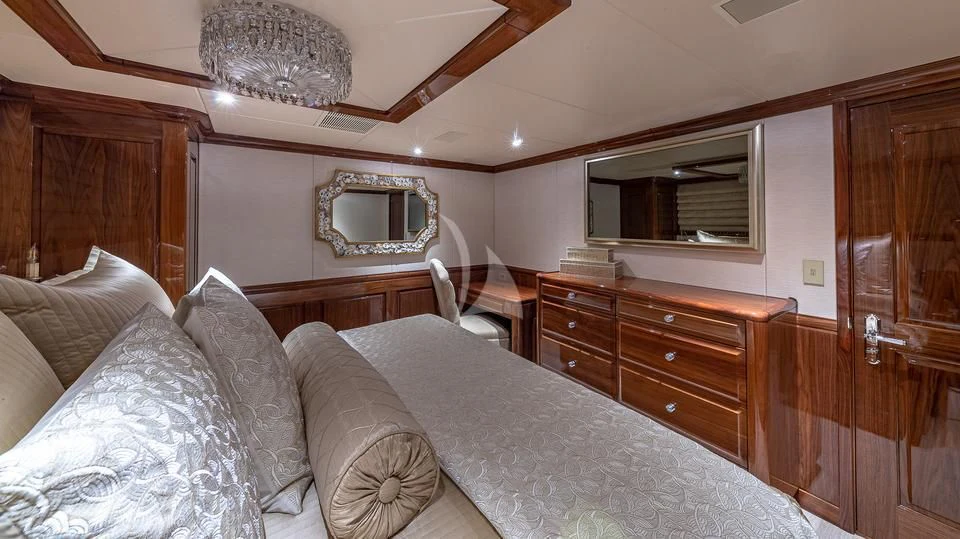 a bedroom with a bed and a television aboard SILVER LINING Yacht for Sale