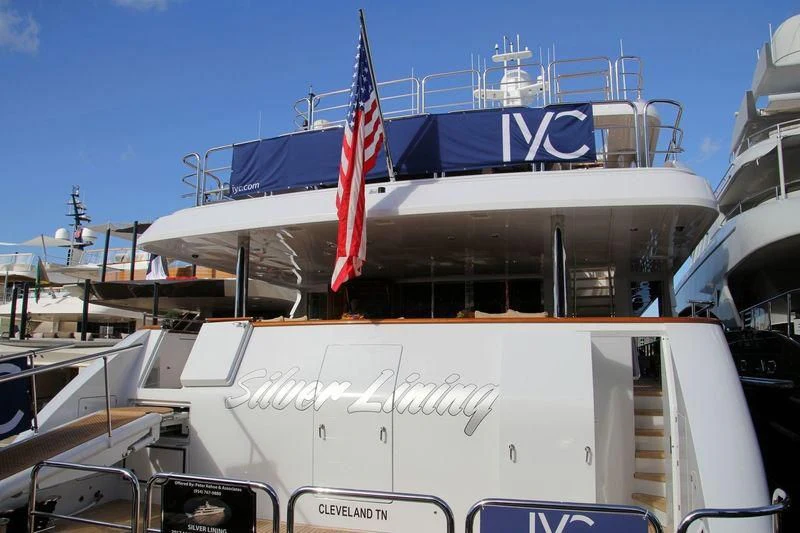 a large ship with a flag on the front aboard SILVER LINING Yacht for Sale