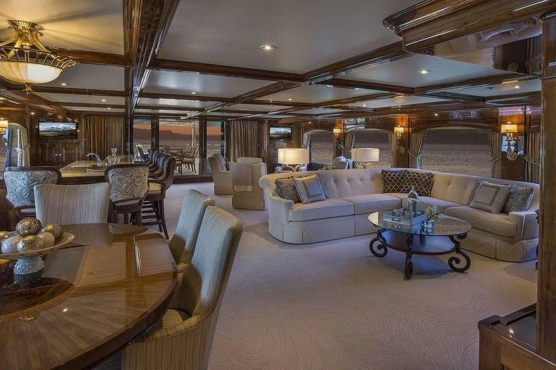 a large living room with a table and chairs aboard SILVER LINING Yacht for Sale