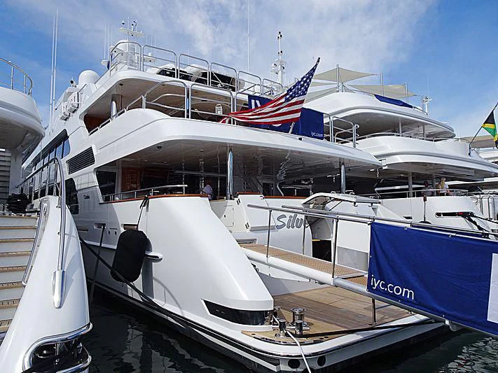 a boat with a flag on the front aboard SILVER LINING Yacht for Sale