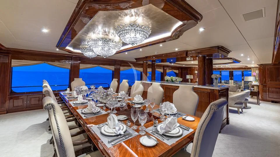 a dining room with a table set for a dinner aboard SILVER LINING Yacht for Sale