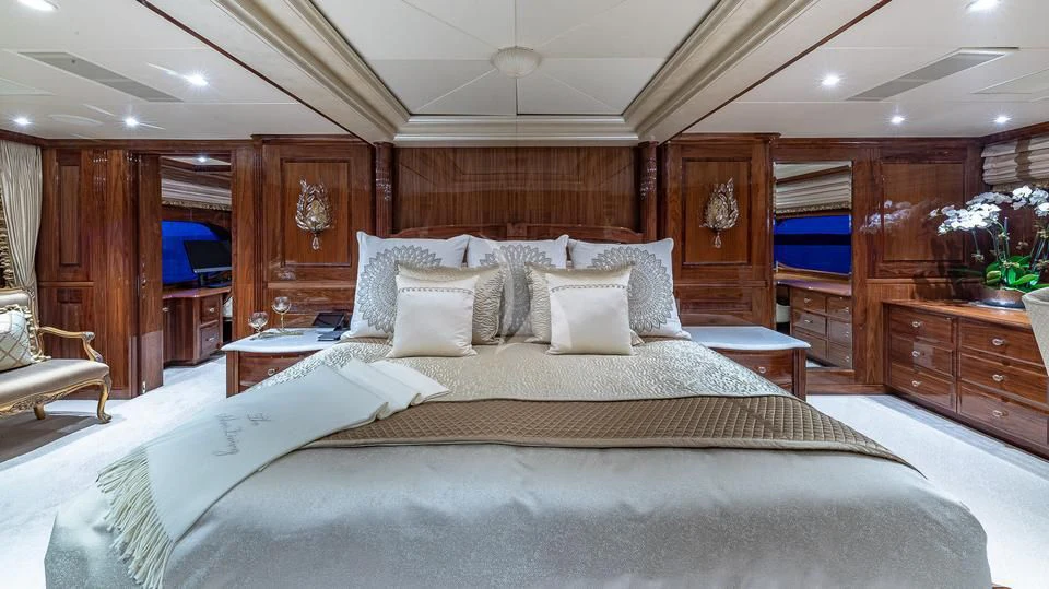 a bed with white sheets and pillows aboard SILVER LINING Yacht for Sale