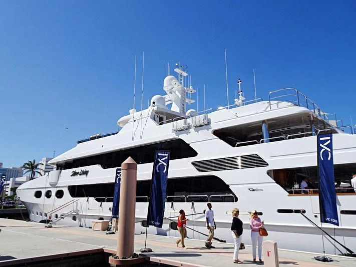 people walking next to a large white ship aboard SILVER LINING Yacht for Sale