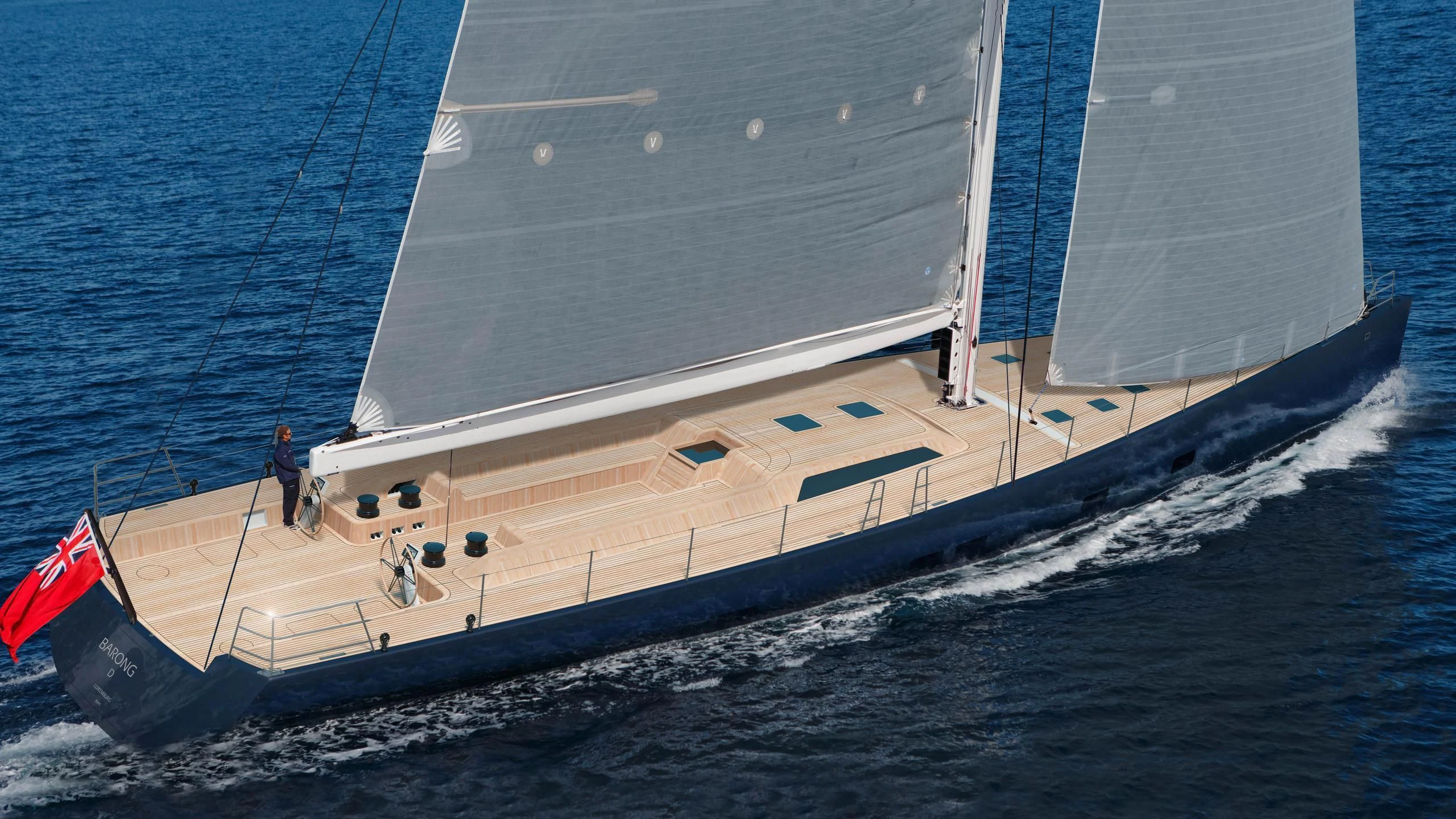 a large white ship with a red flag on the front aboard BARONG D Yacht for Sale