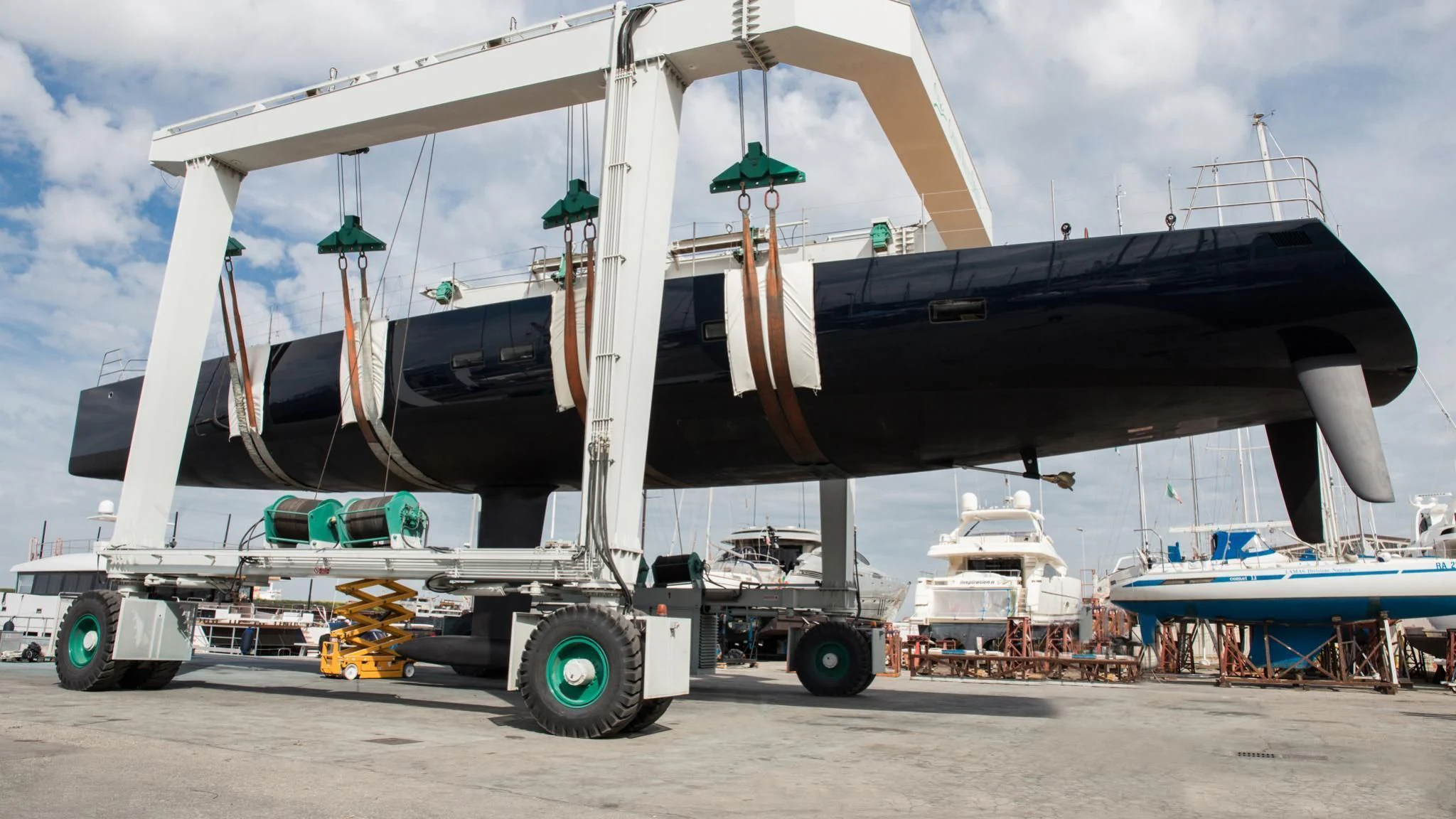 a large white boat on a trailer aboard BARONG D Yacht for Sale