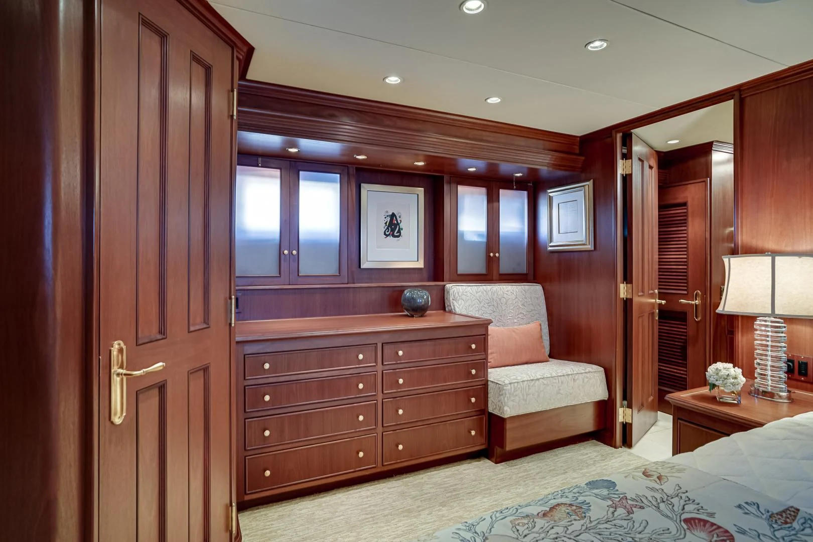 a bedroom with a bed and a chair aboard CHECKERS Yacht for Sale
