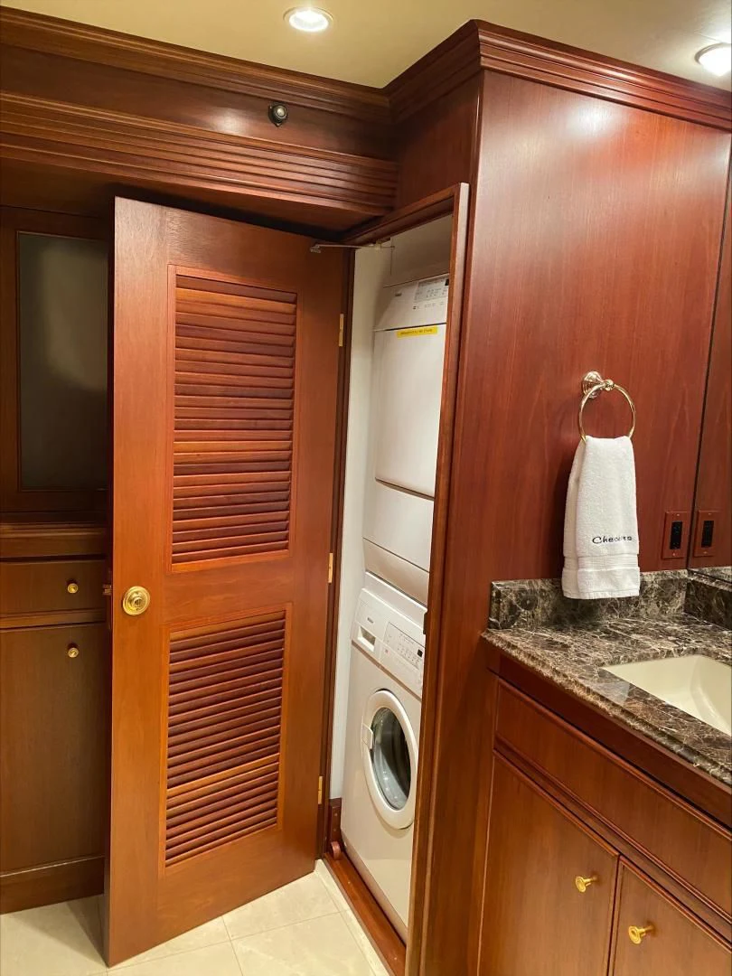 a closet with a washer and dryer in it aboard CHECKERS Yacht for Sale
