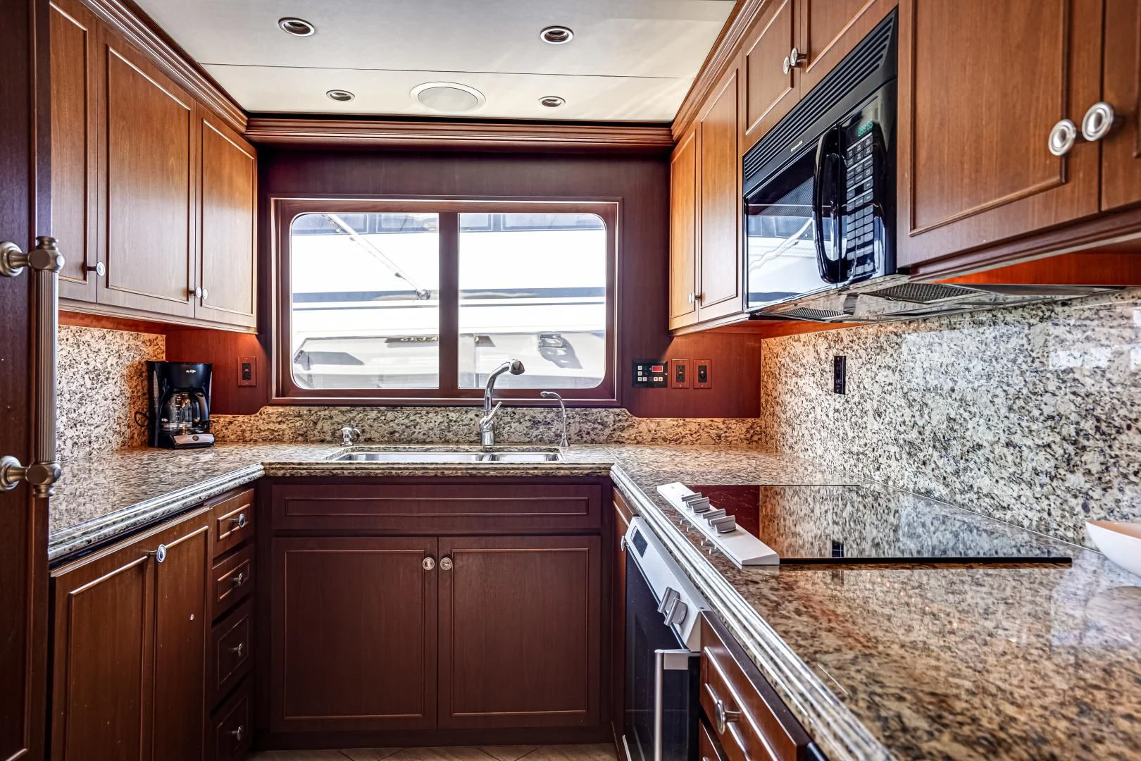 a kitchen with granite counter tops aboard CHECKERS Yacht for Sale