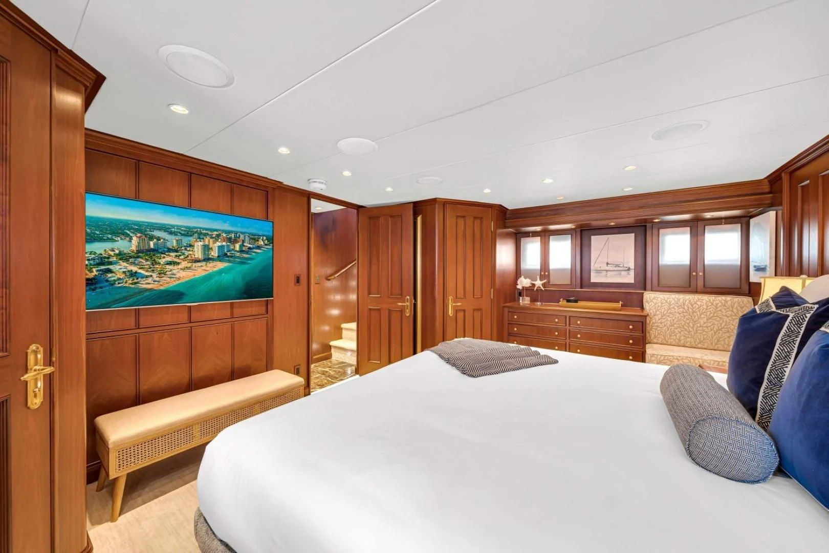 a large bedroom with a large tv aboard CHECKERS Yacht for Sale