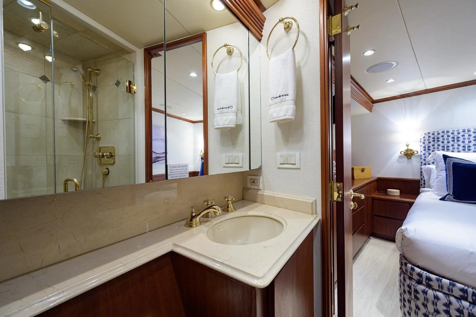 a bathroom with a sink and a bed aboard CHECKERS Yacht for Sale