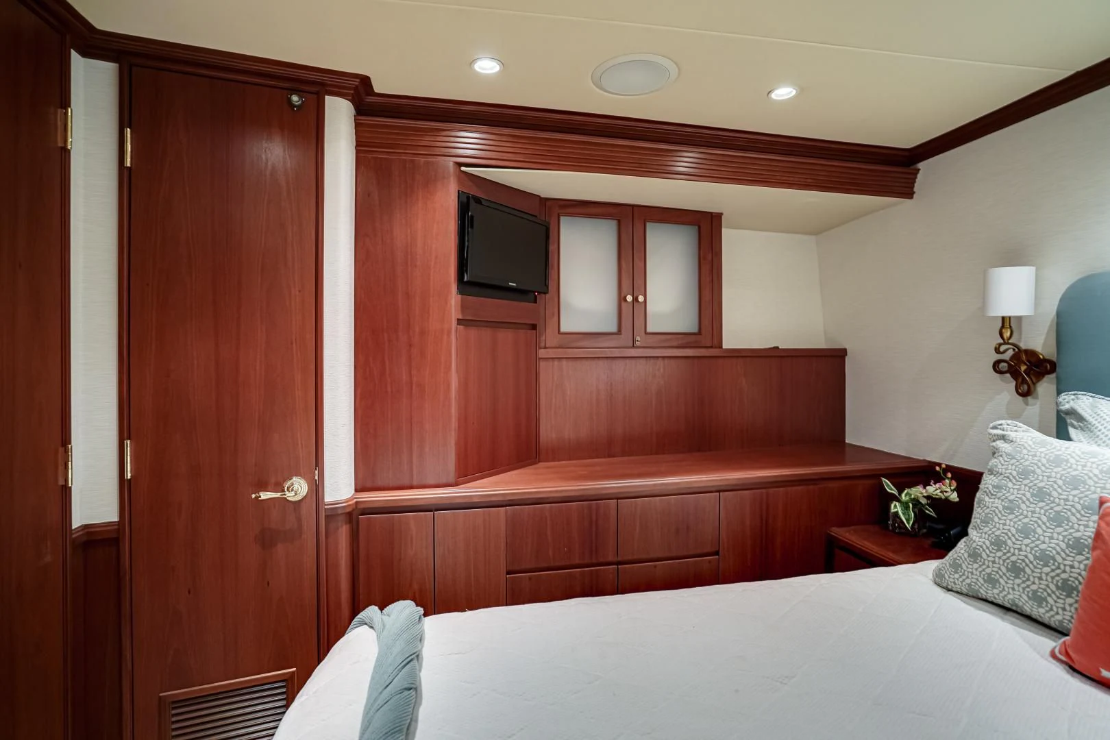 a room with a bed and a wood cabinet aboard CHECKERS Yacht for Sale