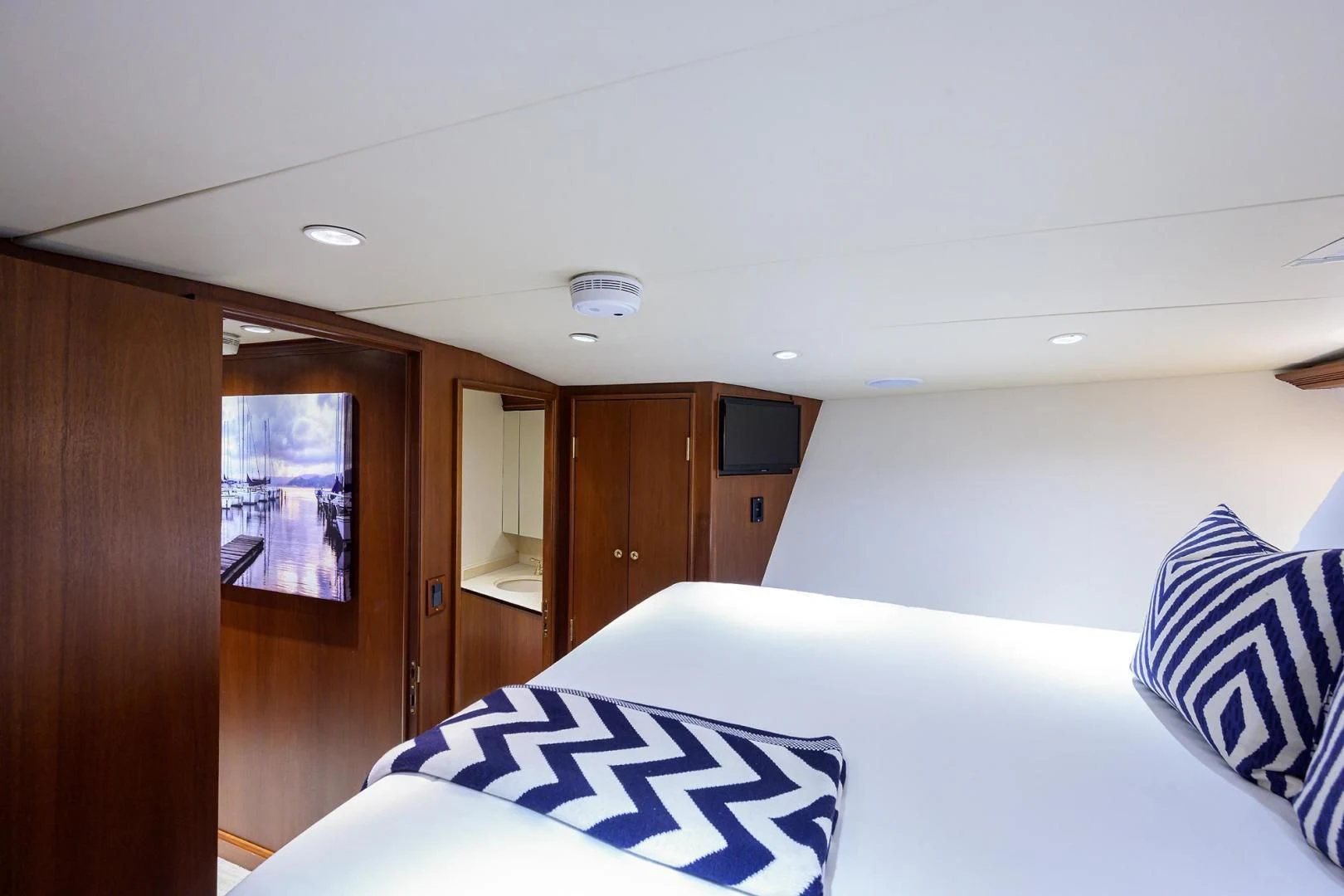a bedroom with a bed and a television aboard CHECKERS Yacht for Sale