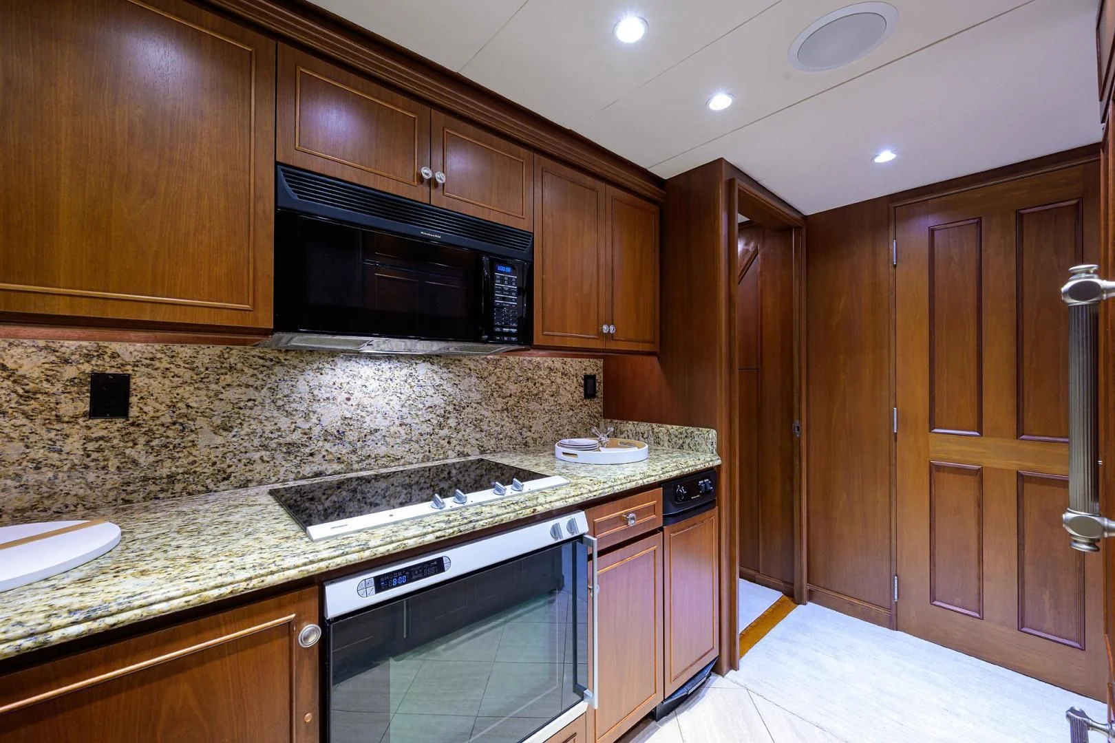 a kitchen with wooden cabinets aboard CHECKERS Yacht for Sale