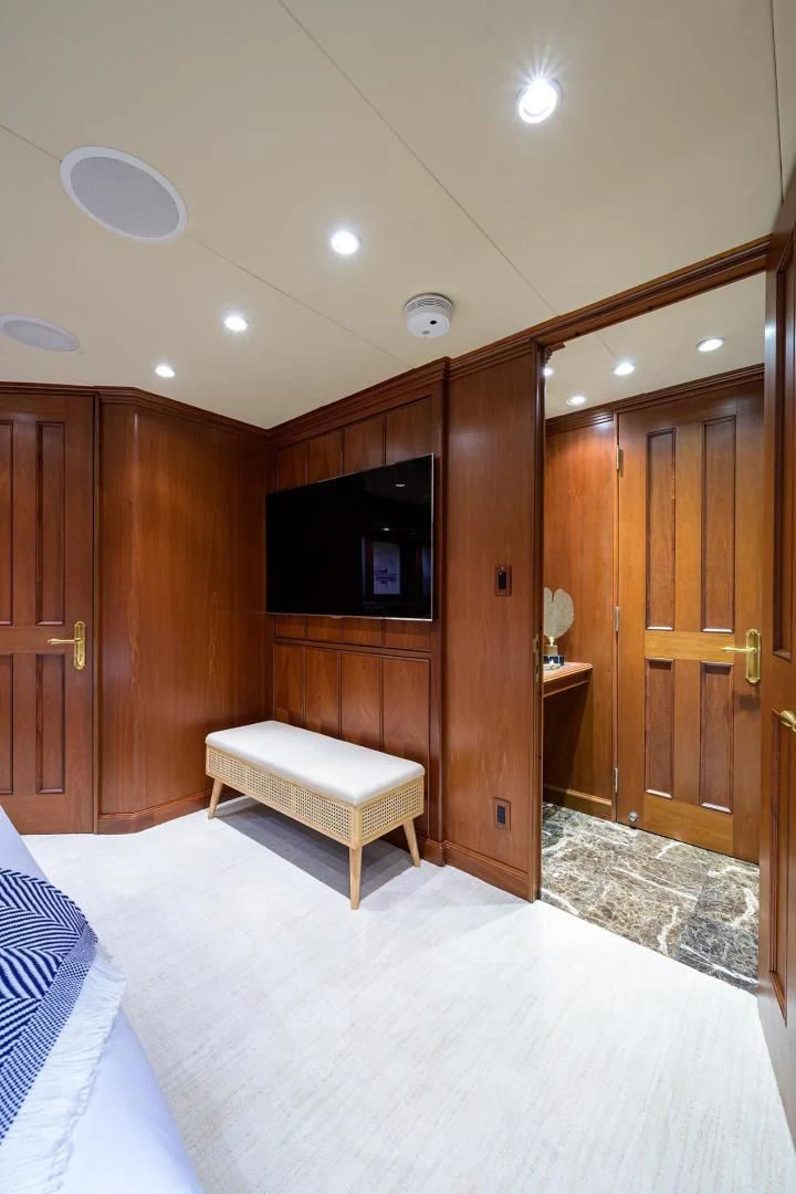 a room with a bed and a tv aboard CHECKERS Yacht for Sale