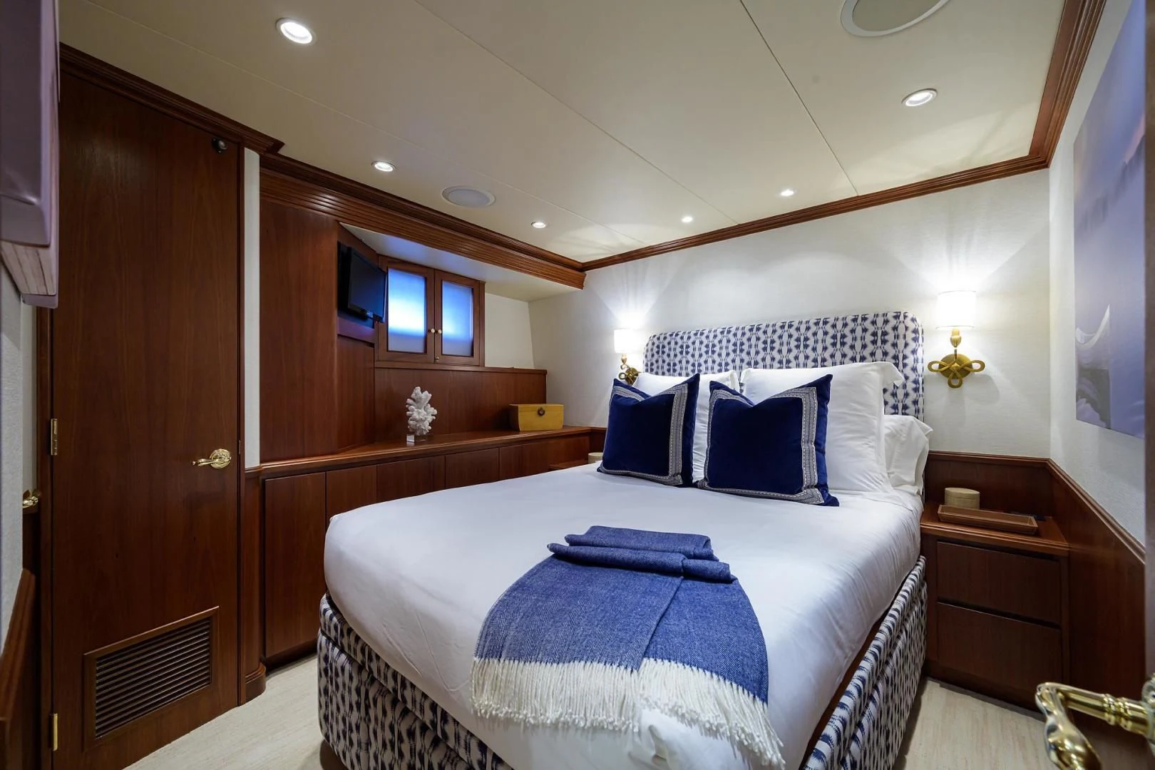 a bedroom with a bed and a closet aboard CHECKERS Yacht for Sale