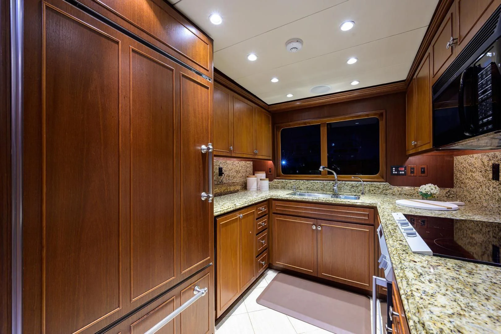a kitchen with wooden cabinets aboard CHECKERS Yacht for Sale