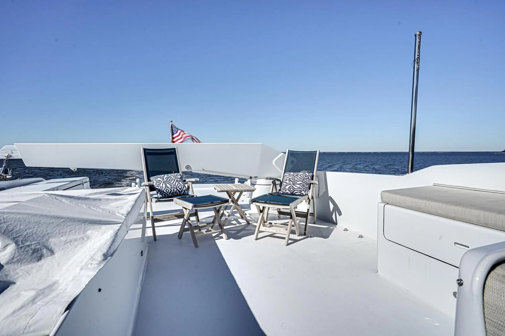 a deck with chairs and tables on it aboard CHECKERS Yacht for Sale